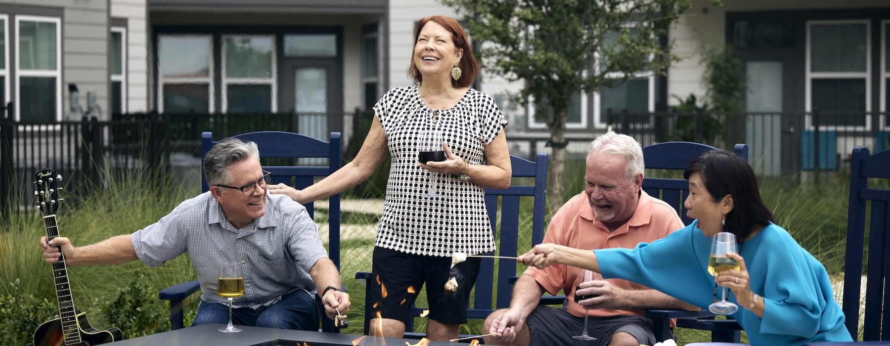 a group of people laughing around a fire